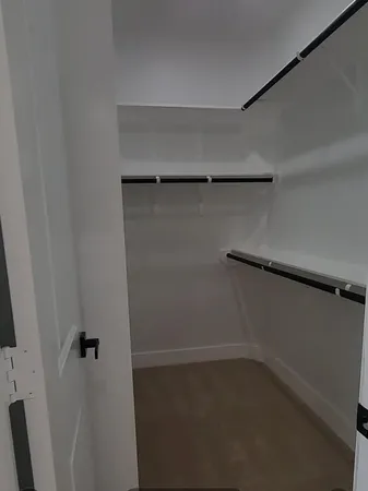 a view of a refrigerator and cabinets