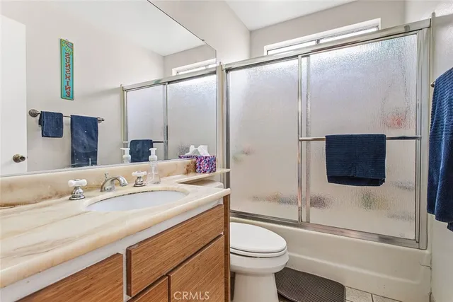 a bedroom with furniture and a flat screen tv