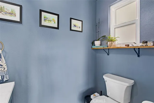 a bathroom with a toilet sink and window