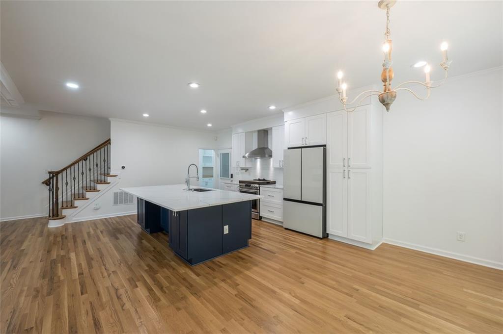 1018 Berne Street Southeast Atlanta, GA 30316 - Photo 12 of 34 a living room with kitchen island wooden floor and ceiling fan