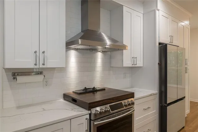 a stove top oven sitting inside of a kitchen