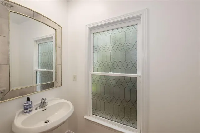 a bathroom with a sink a mirror and shower