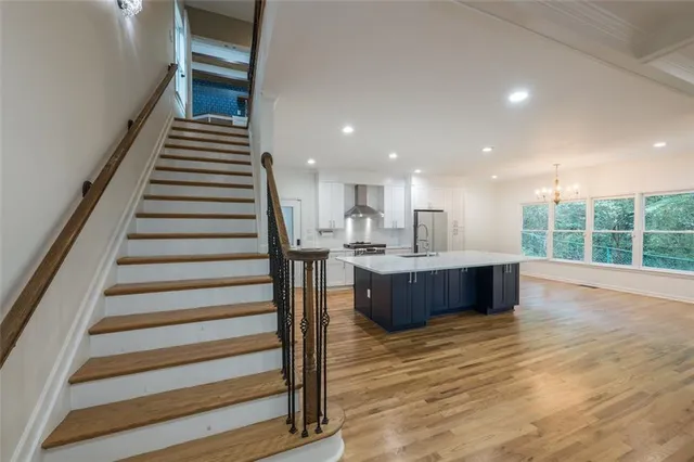 a view of kitchen with wooden floor and electronic appliances