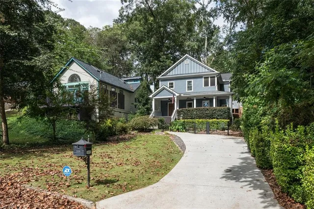 a front view of a house with a yard and trees