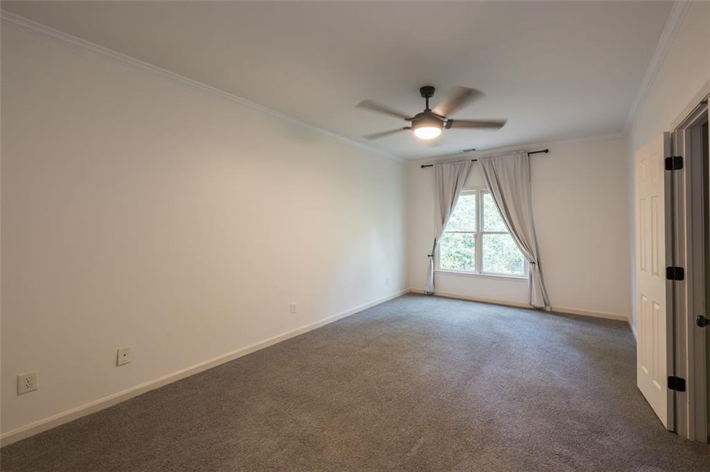1018 Berne Street Southeast Atlanta, GA 30316 - Photo 31 of 34 an empty room with a window and a chandelier fan