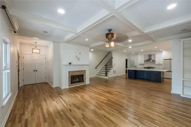 a view of kitchen and hall with wooden floor