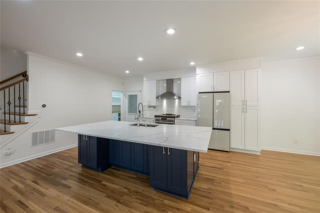 1018 Berne Street Southeast Atlanta, GA 30316 - Photo 10 of 34 a kitchen with stainless steel appliances granite countertop a sink cabinets and wooden floor