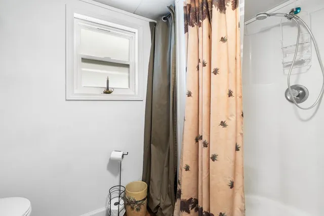 a living room with furniture dining area and a window