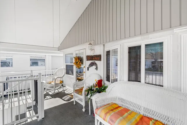 a view of a house with a backyard and sitting area