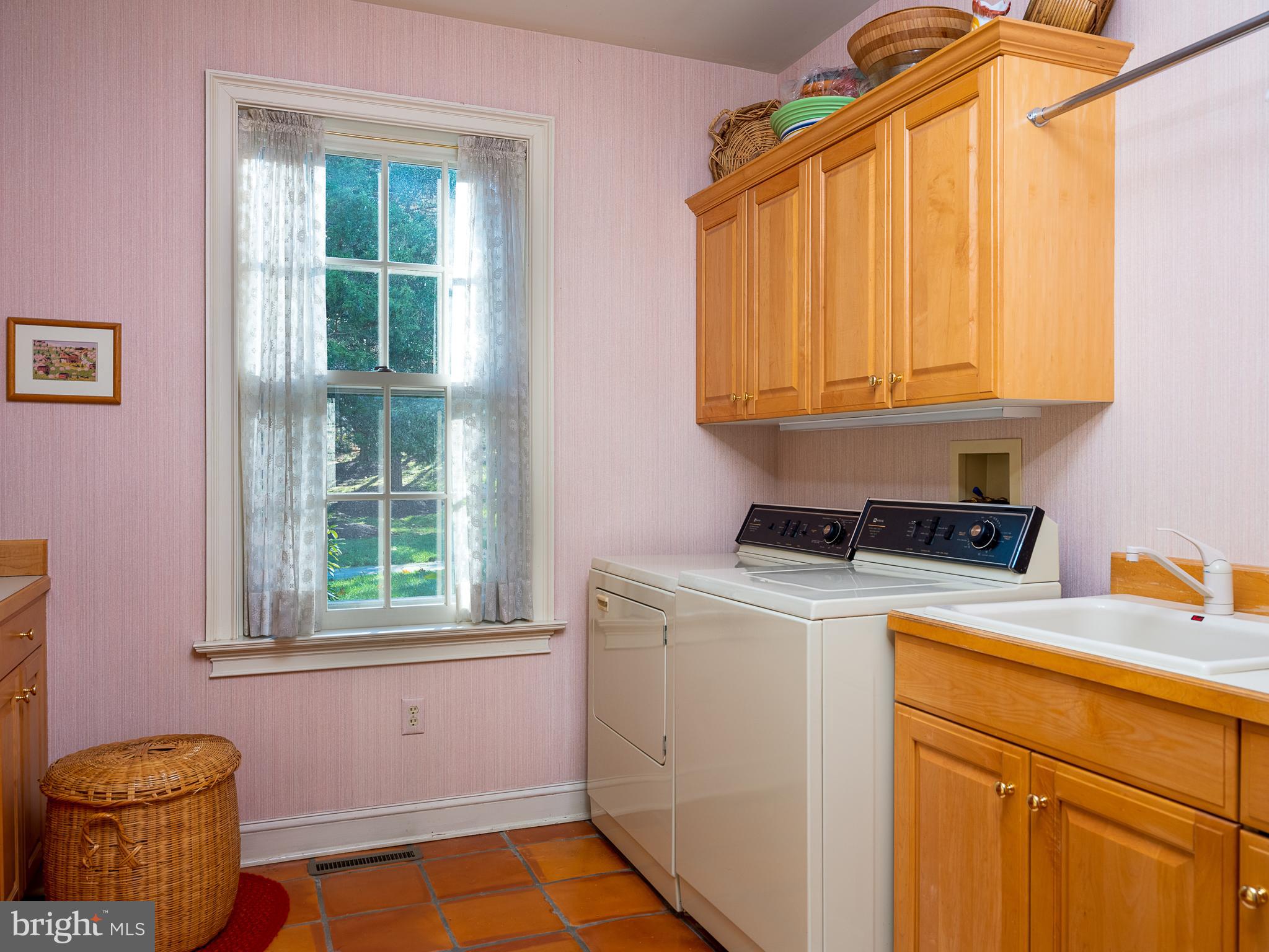 3 Round Hill Road Newtown, PA 18940 - Photo 22 of 43 Main level laundry room with sink and storage