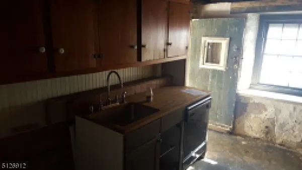 a close view of a sink and cabinets