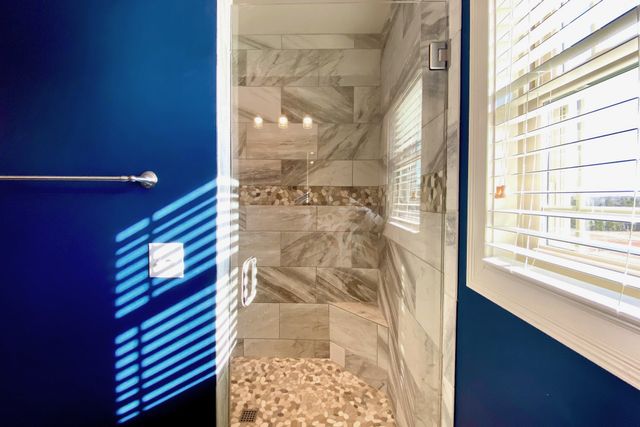 a bathroom with a bathtub and shower