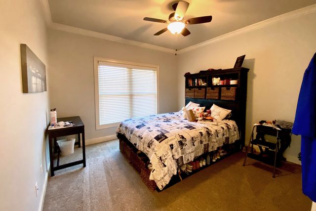 a bedroom with a bed and a chandelier