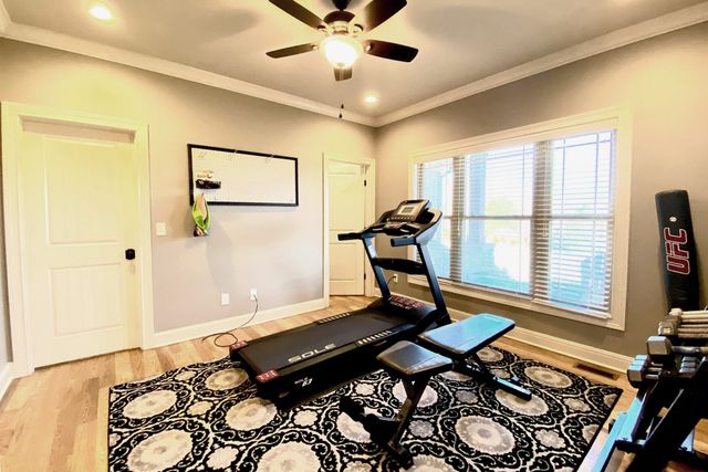 a living room with a bed and a flat screen tv