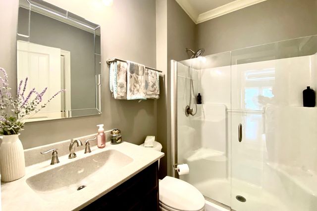 a bathroom with a sink vanity mirror and toilet
