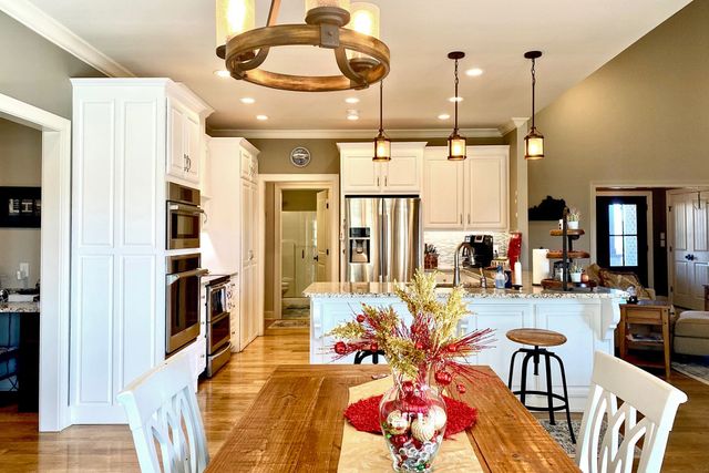 a lobby room with furniture and chandelier