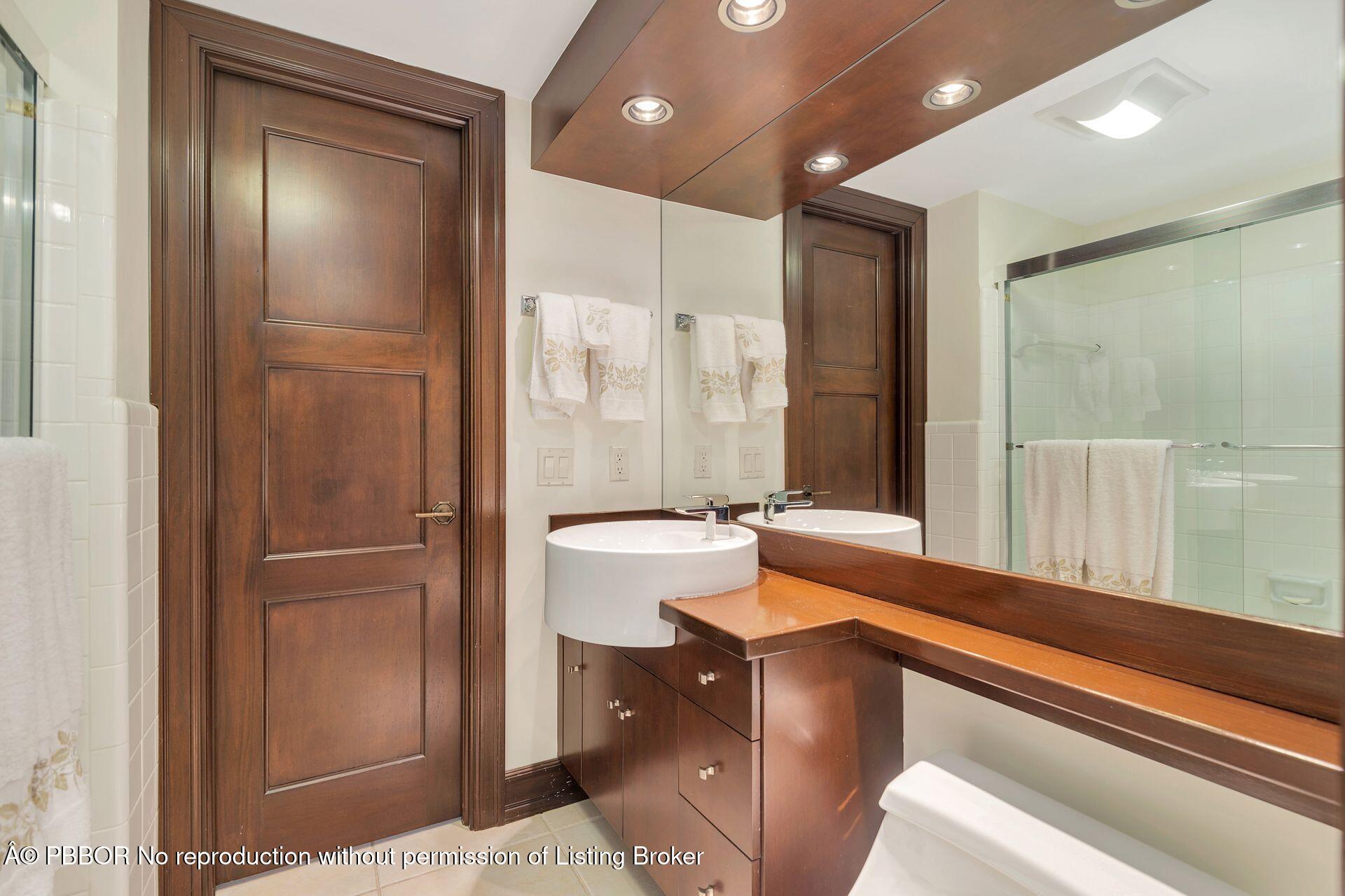 170 North Ocean Boulevard, Unit 409 Palm Beach, FL 33480 - Photo 15 of 34 a bathroom with a tub and a shower