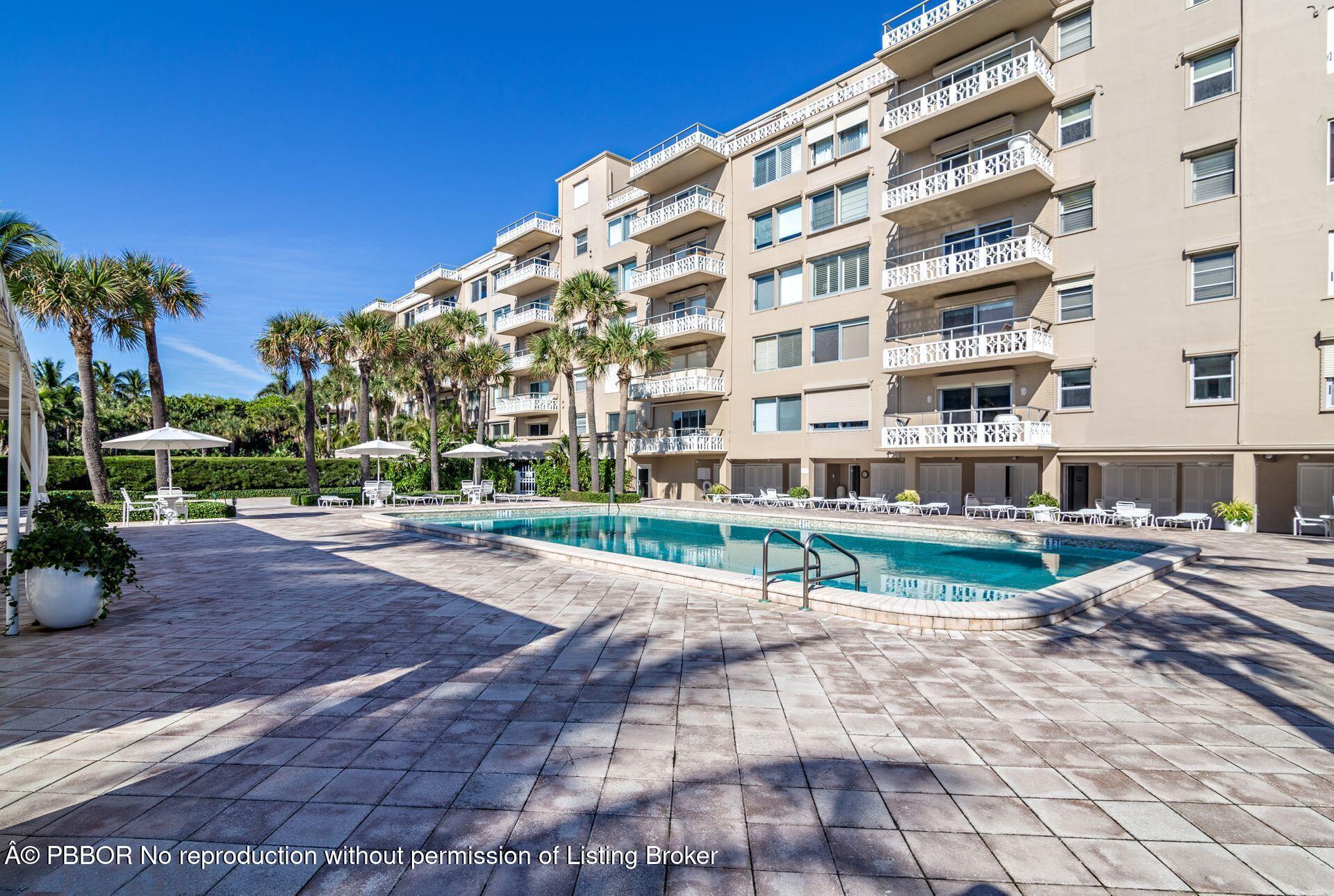 170 North Ocean Boulevard, Unit 409 Palm Beach, FL 33480 - Photo 24 of 34 a view of a tall building with a yard