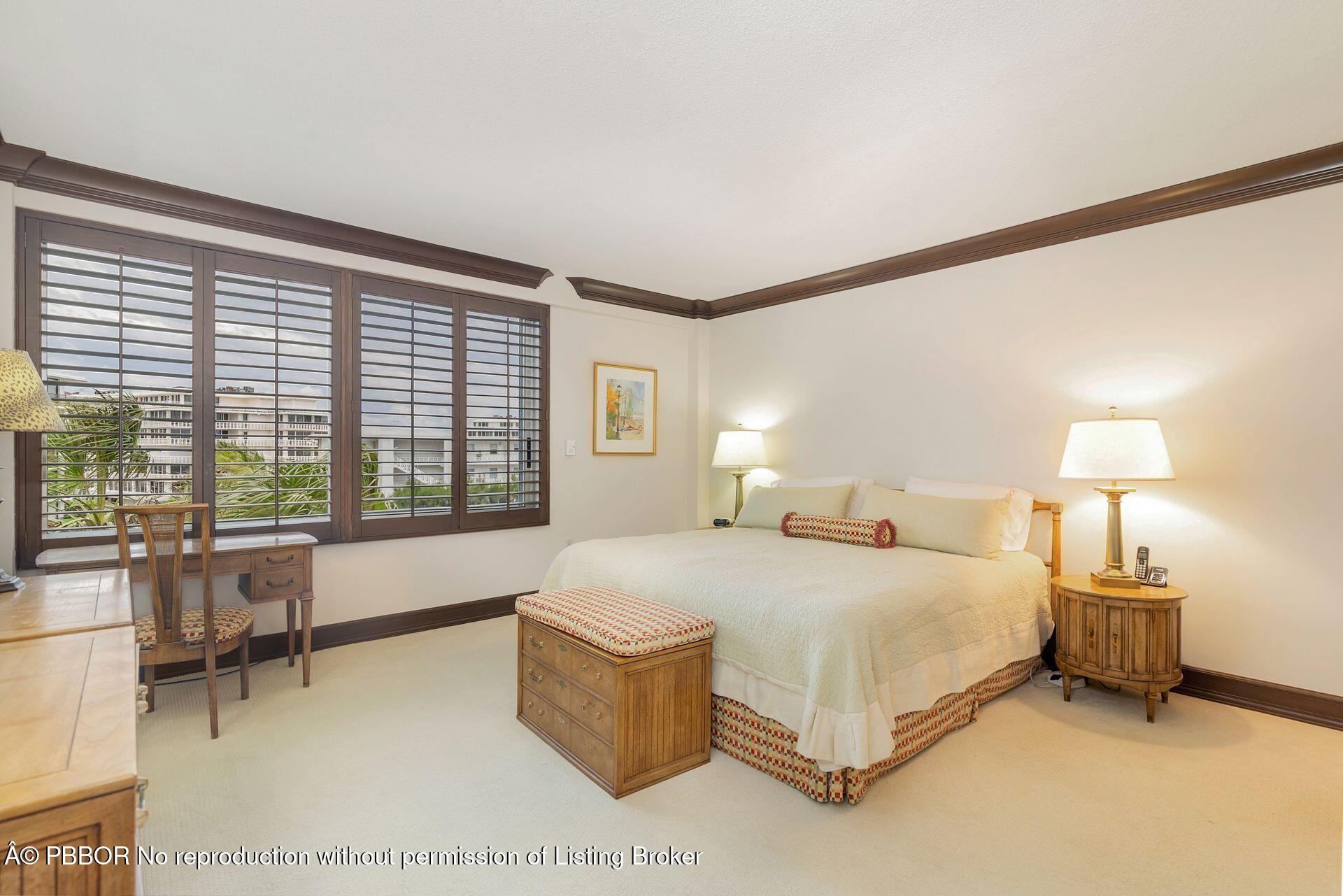 170 North Ocean Boulevard, Unit 409 Palm Beach, FL 33480 - Photo 10 of 34 a bedroom with a large bed and a large window