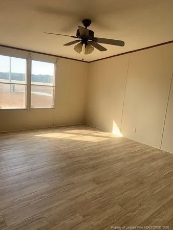 a view of a room with wooden floor and windows