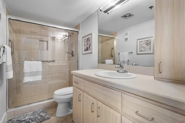 a bathroom with a sink toilet and shower