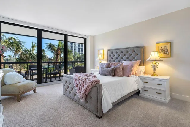 a spacious bedroom with a bed and a large window