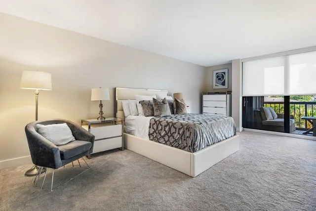 a spacious bedroom with a bed and a couch