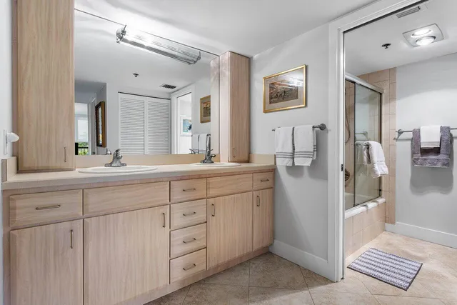 a spacious bathroom with double sink and a mirror