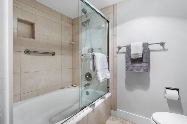 a bathroom with a bathtub and a shower