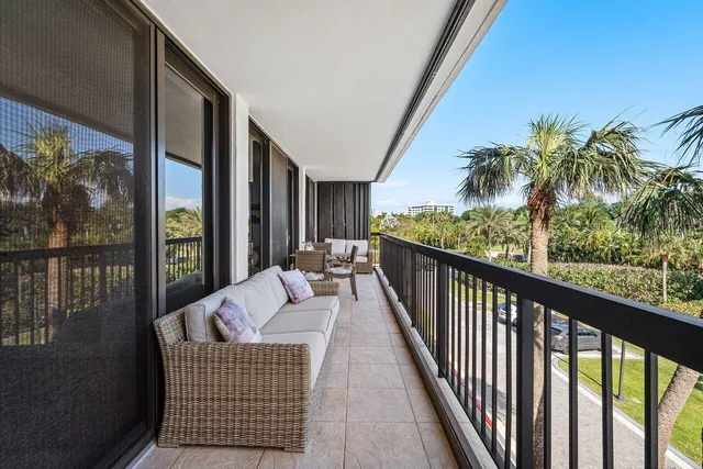 a balcony with furniture and potted plants
