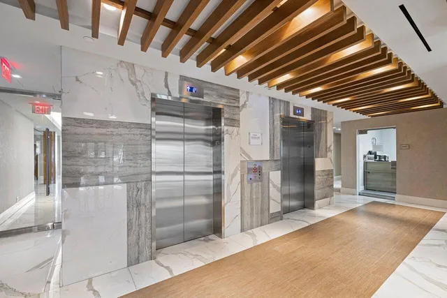 a view of a hallway with wooden cabinets