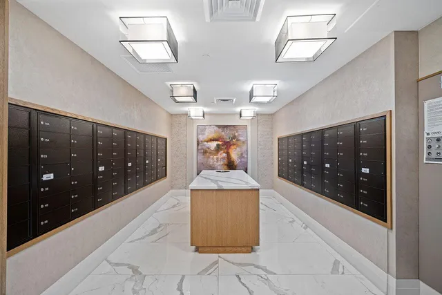 a hallway with a large mirror and sink