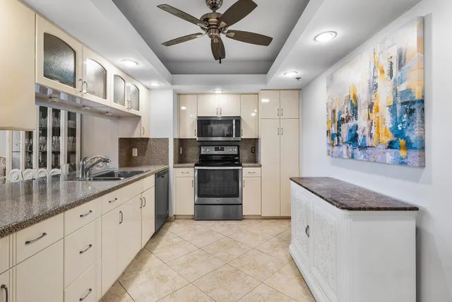 a kitchen with stainless steel appliances granite countertop a refrigerator and a sink