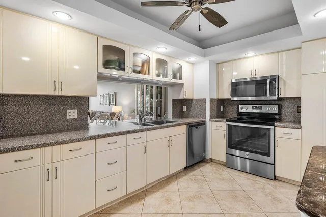 a kitchen with stainless steel appliances granite countertop a stove sink and cabinets