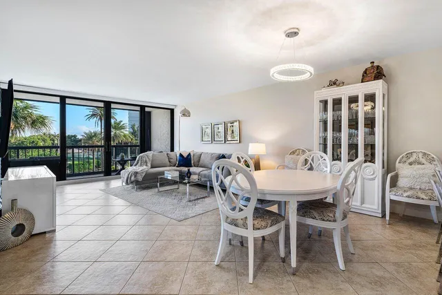 a view of a dining room with furniture a chandelier and wooden floor