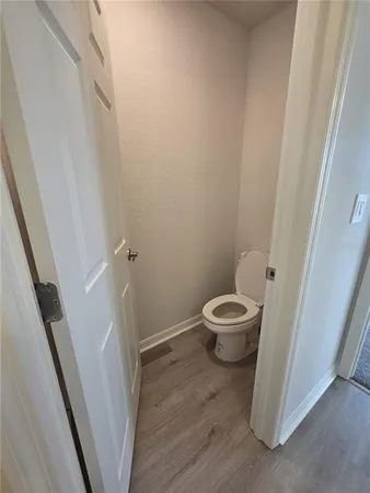 a bathroom with a granite countertop sink a toilet and shower