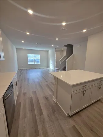 a large white room with wooden floors