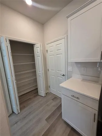 a utility room with wooden floor washer and dryer