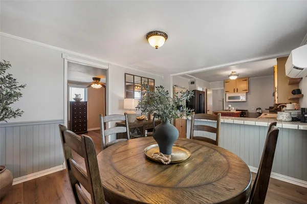 a dining room with furniture and wooden floor
