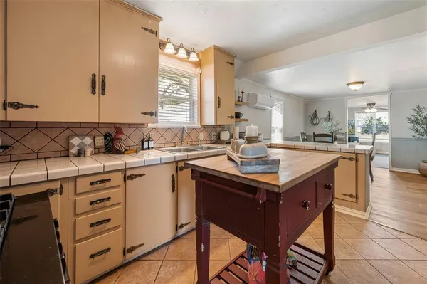 a kitchen with a sink stove and cabinets