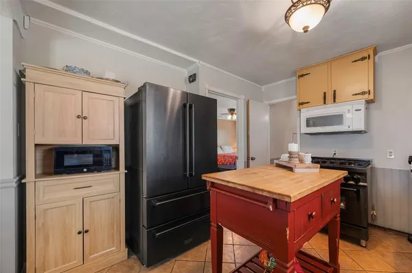 a kitchen with a refrigerator and a sink