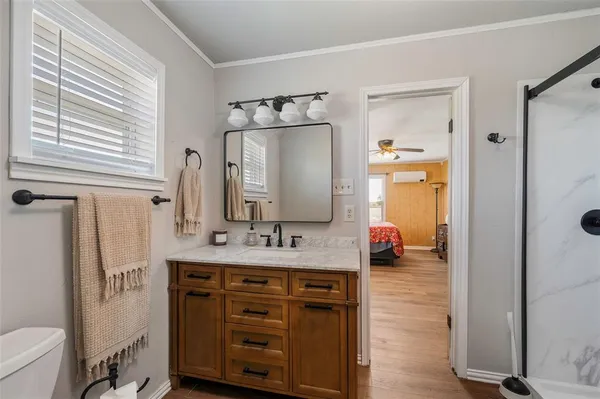a bathroom with a sink vanity granite tub and shower