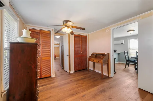 a view of a hallway with wooden floor and furniture