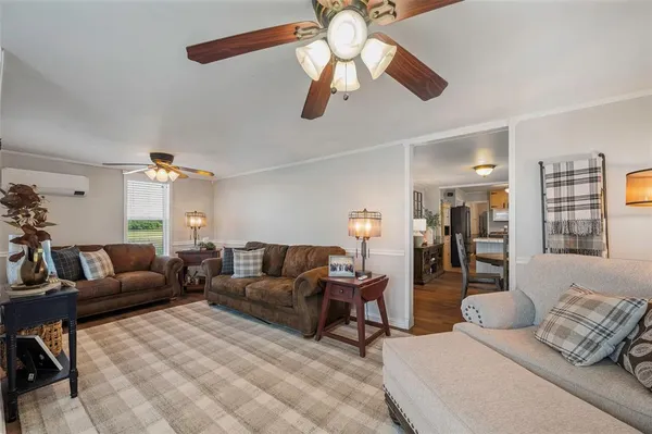 a living room with furniture ceiling fan and a rug