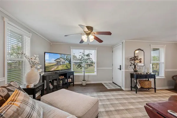 a living room with furniture and a flat screen tv