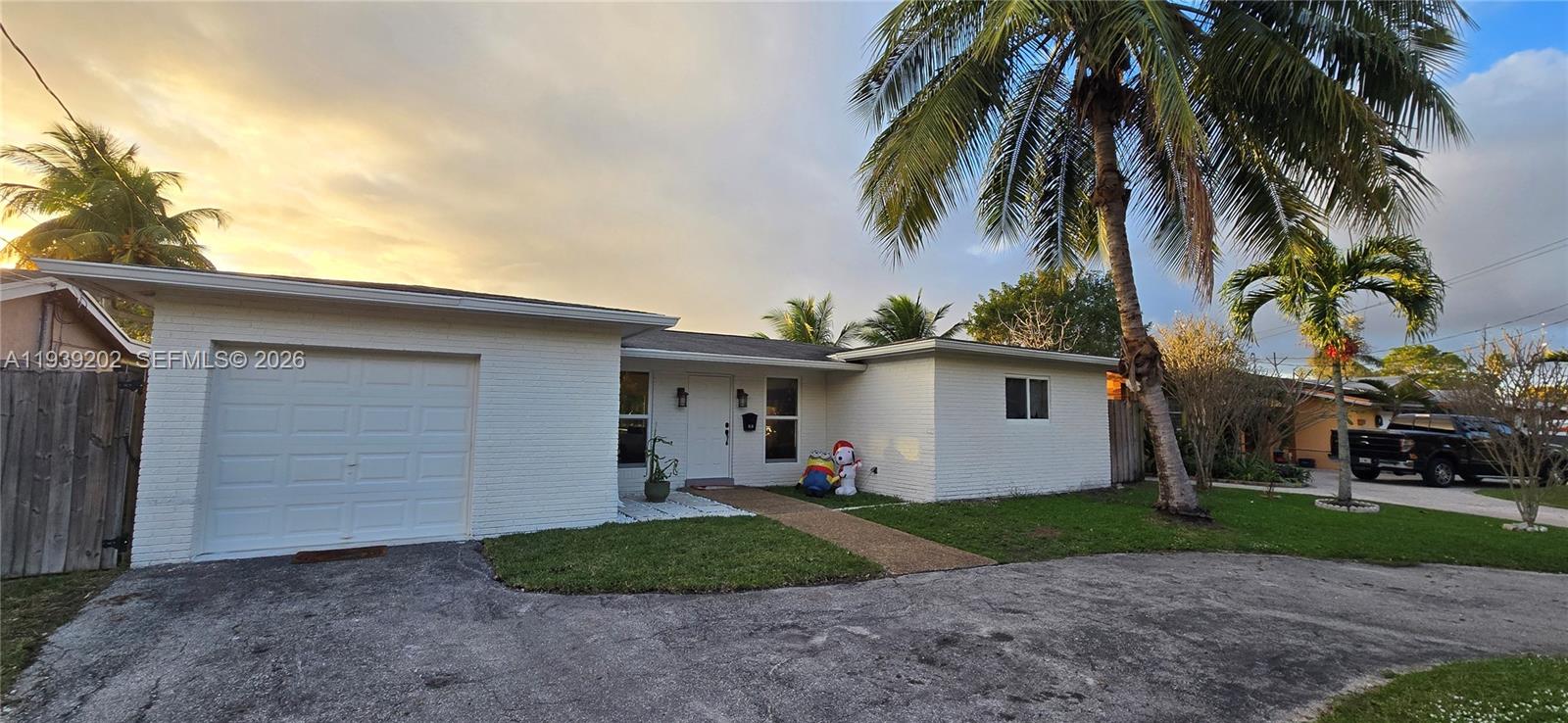 4012 East Shore Road Miramar, FL 33023 - Photo 1 of 22 a view of a house with a yard and palm trees