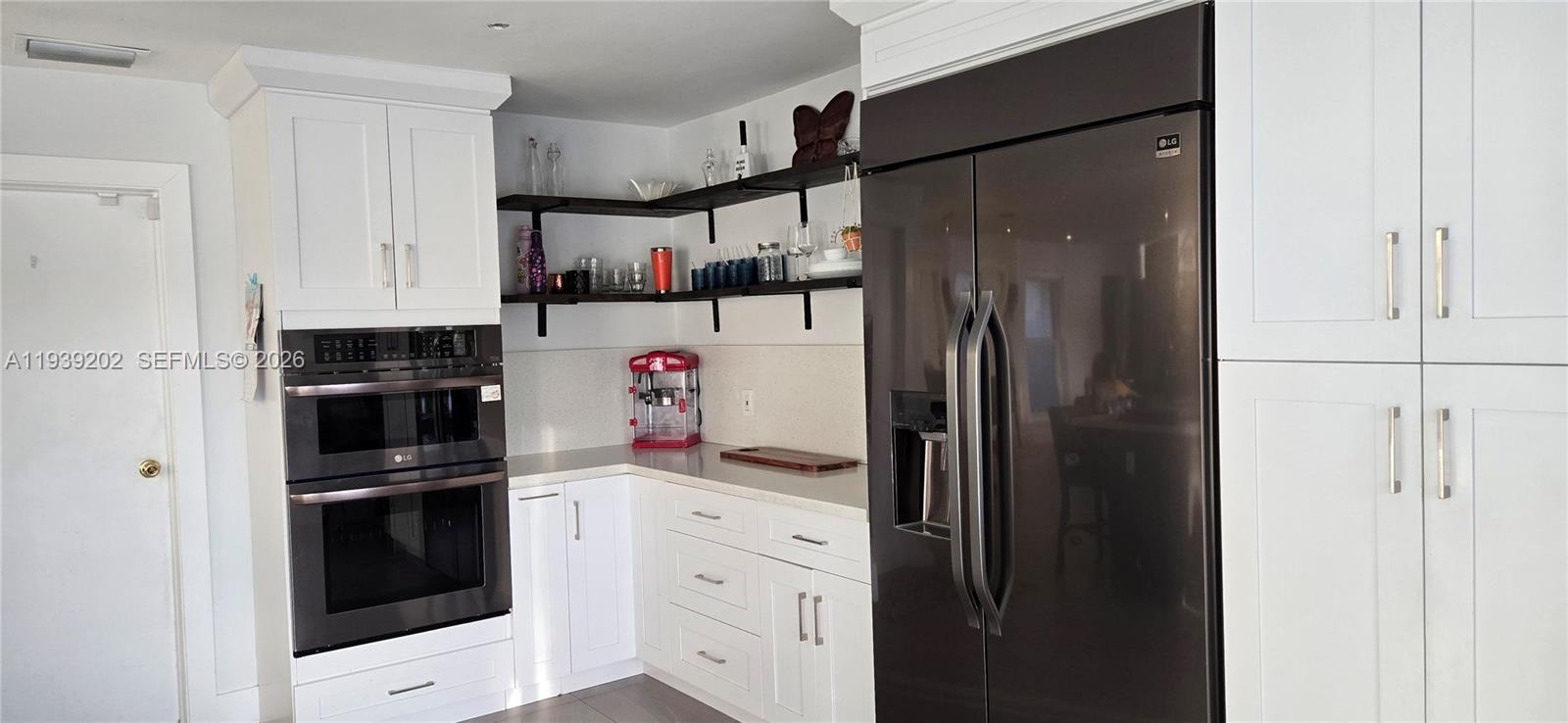 4012 East Shore Road Miramar, FL 33023 - Photo 14 of 22 a kitchen with refrigerator and cabinets