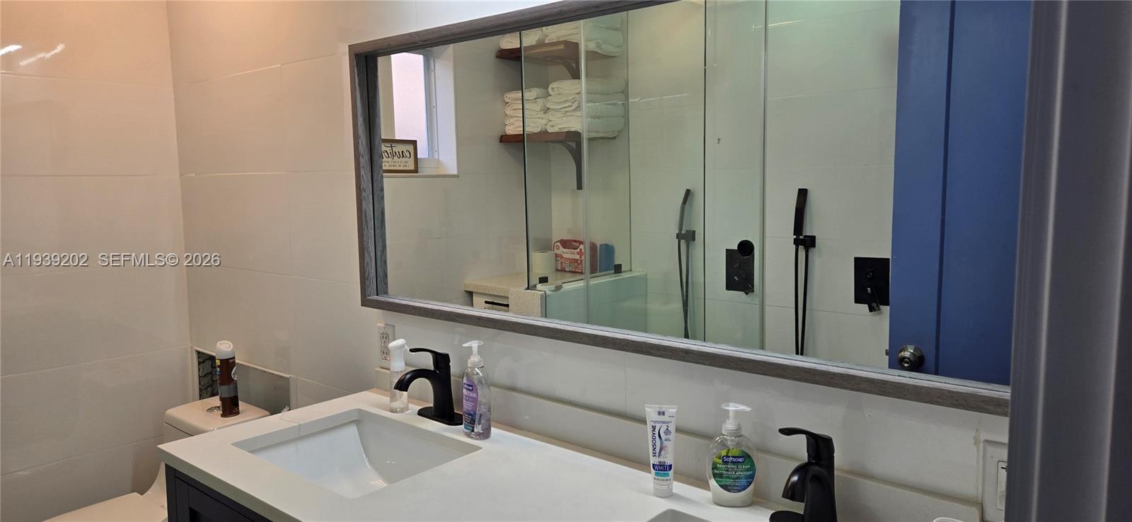 4012 East Shore Road Miramar, FL 33023 - Photo 22 of 22 a bathroom with a sink and a mirror