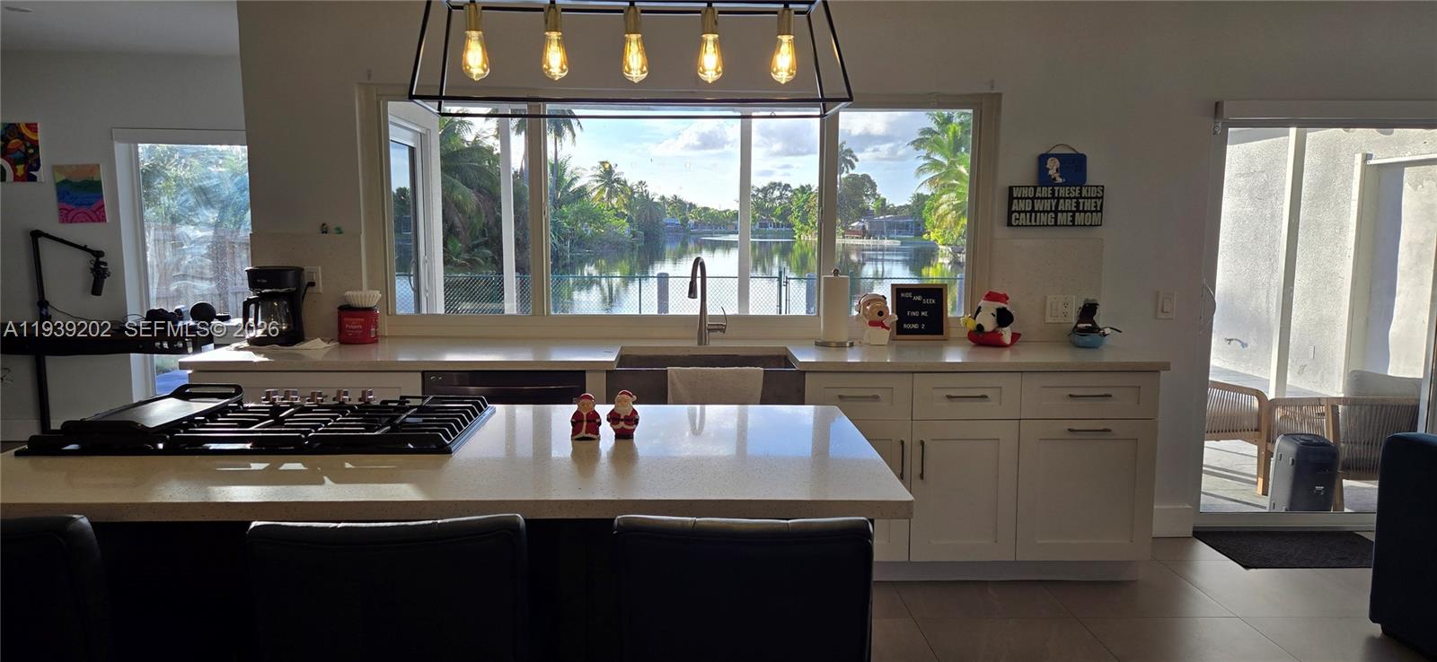 4012 East Shore Road Miramar, FL 33023 - Photo 7 of 22 a kitchen with a sink stove and cabinets