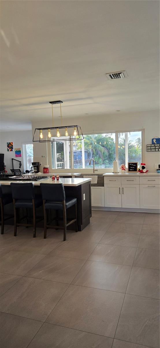 4012 East Shore Road Miramar, FL 33023 - Photo 8 of 22 a kitchen with stainless steel appliances a sink and cabinets
